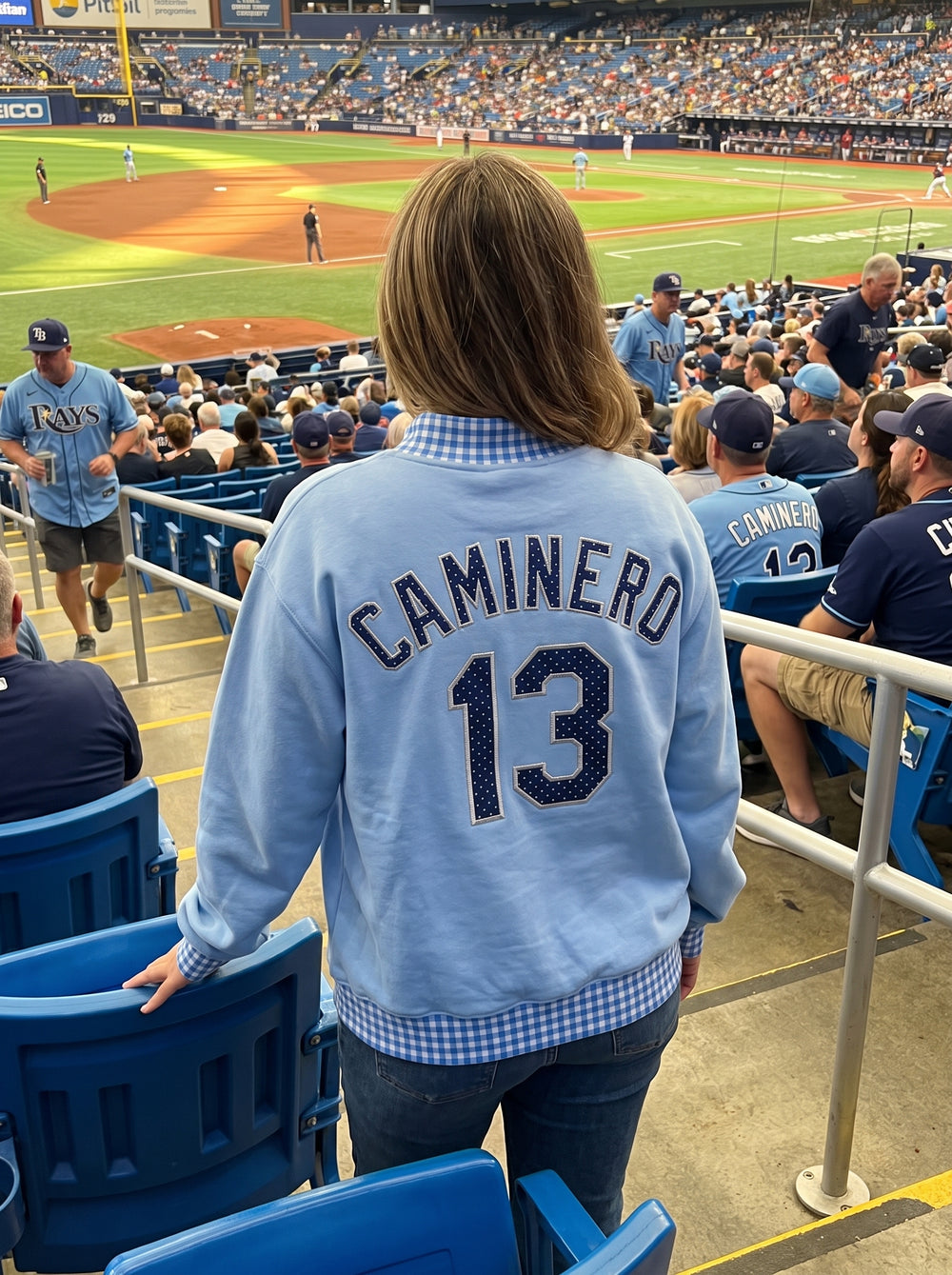 No. 13 on the back, watching the ninth from the stands.