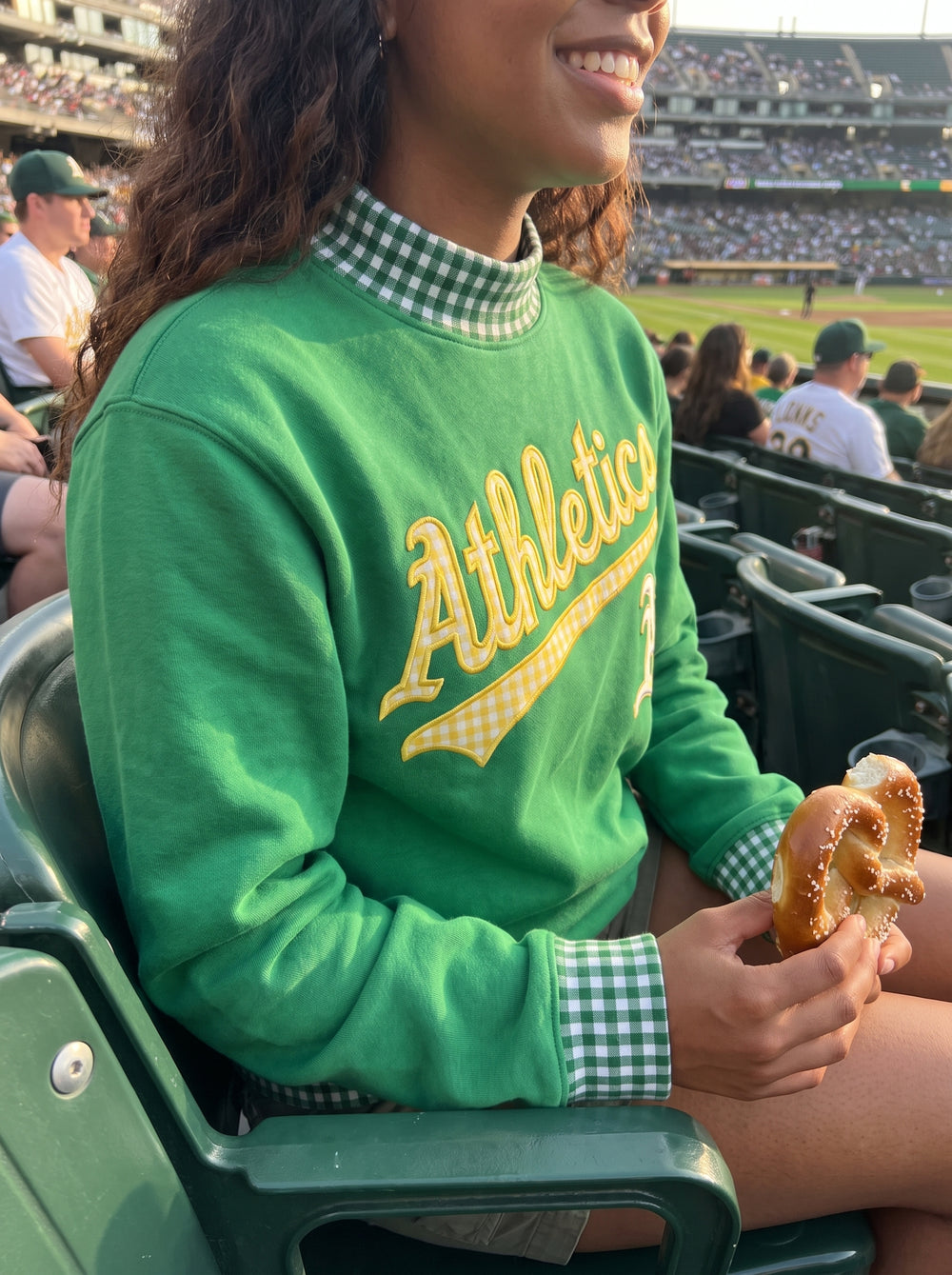 Pretzel in one hand, gingham cuffs on both.